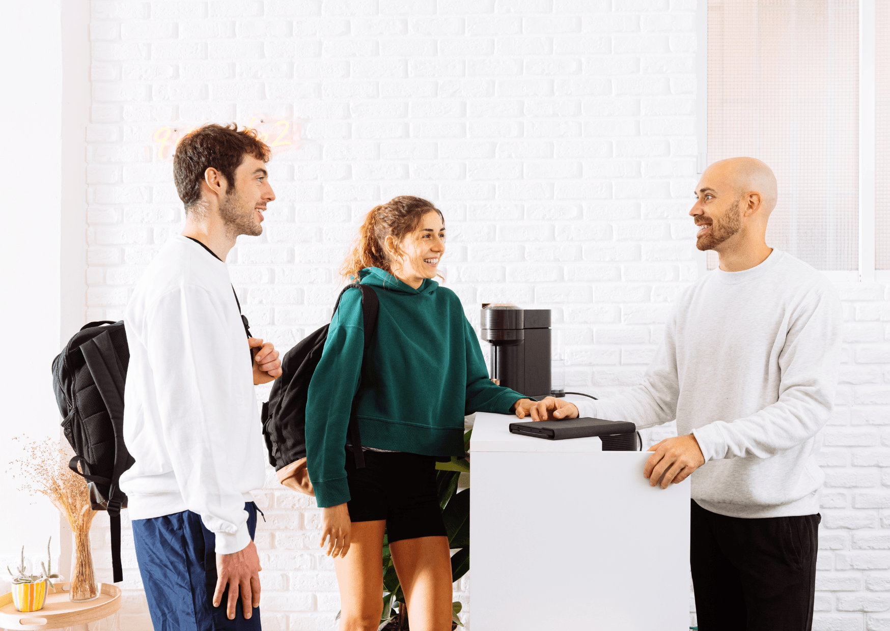 Two guests making a direct booking at a hotel reception counter.