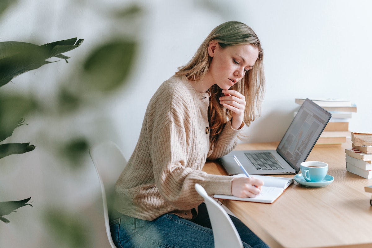 A woman sitting at a desk planning a retreat.