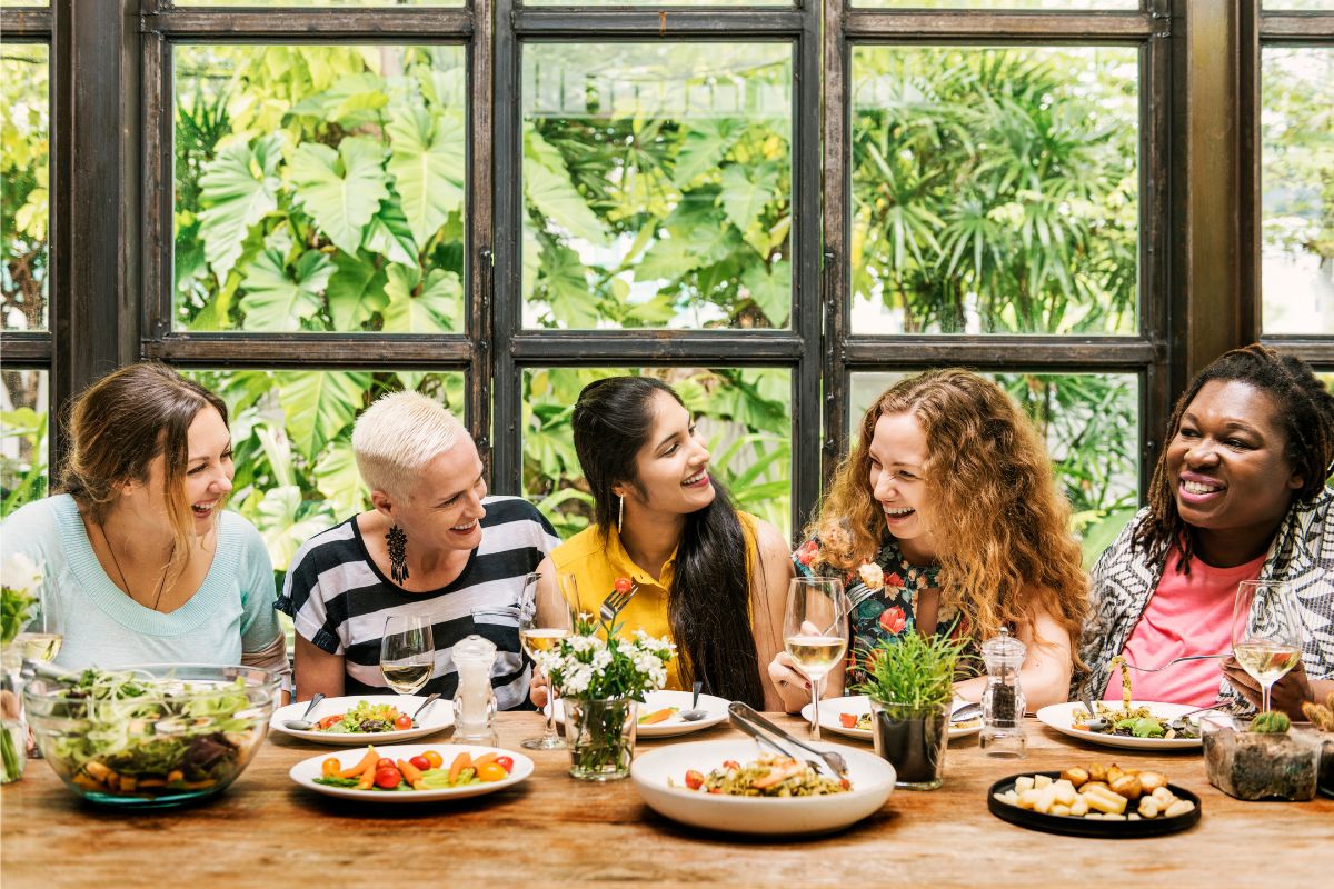 Women enjoying a meal from a well-planned retreat menu.