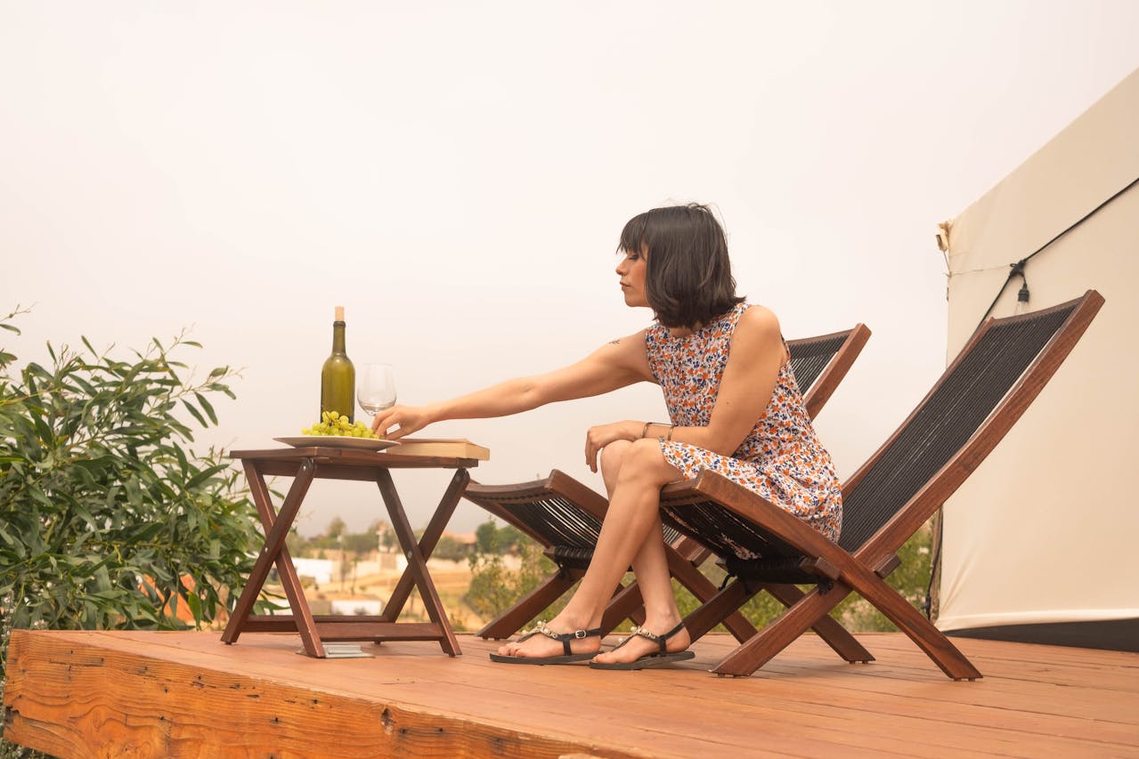 A women enjoying an in-room wine upsell at a glamping site.